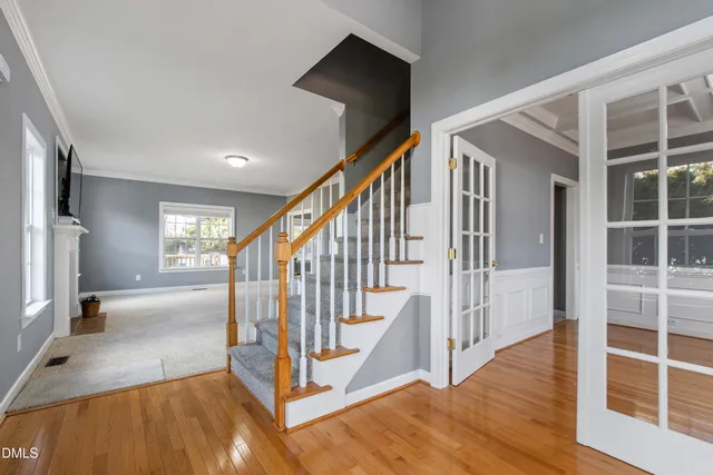 a view of a hallway with wooden floor and entryway