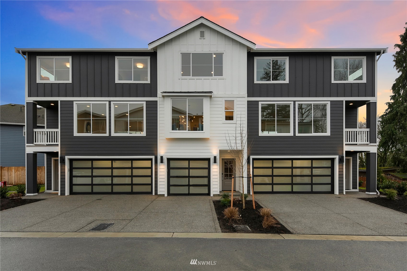 16030 Meadow Road, Unit A3 Lynnwood, WA 98087 - Photo 1 of 1 a front view of a house with a yard and garage