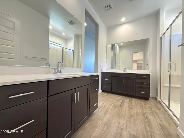 a spacious bathroom with a double vanity sink and a mirror