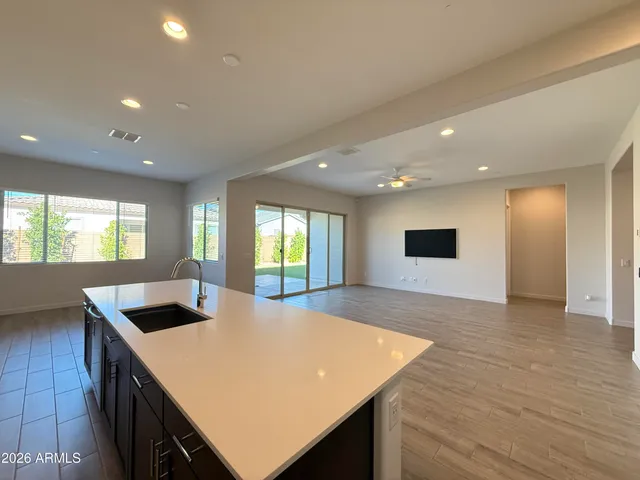 a view of kitchen and hall with wooden floor