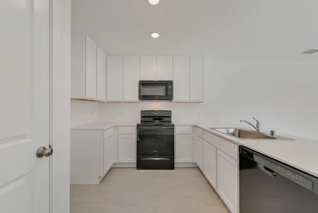 a kitchen with a sink and a stove top oven