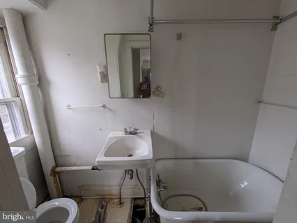 a kitchen with stainless steel appliances a stove a refrigerator a sink a counter top space and cabinets