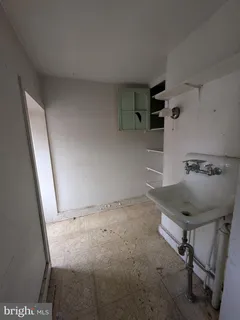 a kitchen with stainless steel appliances a sink a stove a refrigerator and cabinets