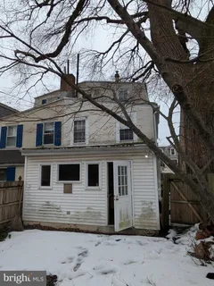 a picture of a room with a white wall and a large window