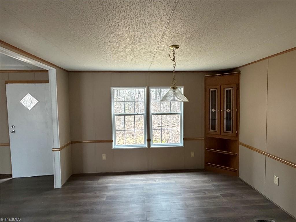 670 Foxwood Road Madison, NC 27025 - Photo 7 of 15 Dining room view from the kitchen…. There is a doorway from dining room to kitchen and also a door from dining room on the right to the Primary bedroom. Door you are seeing is the front door