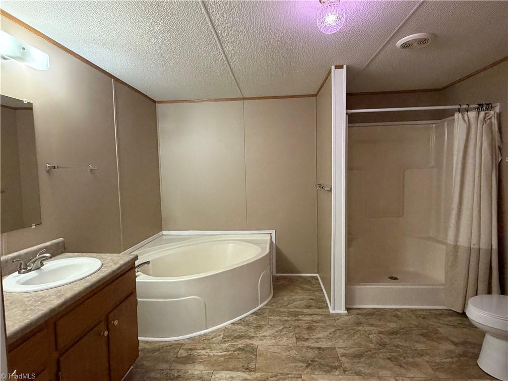 670 Foxwood Road Madison, NC 27025 - Photo 9 of 15 Primary bathroom with large garden tub and stand up shower.