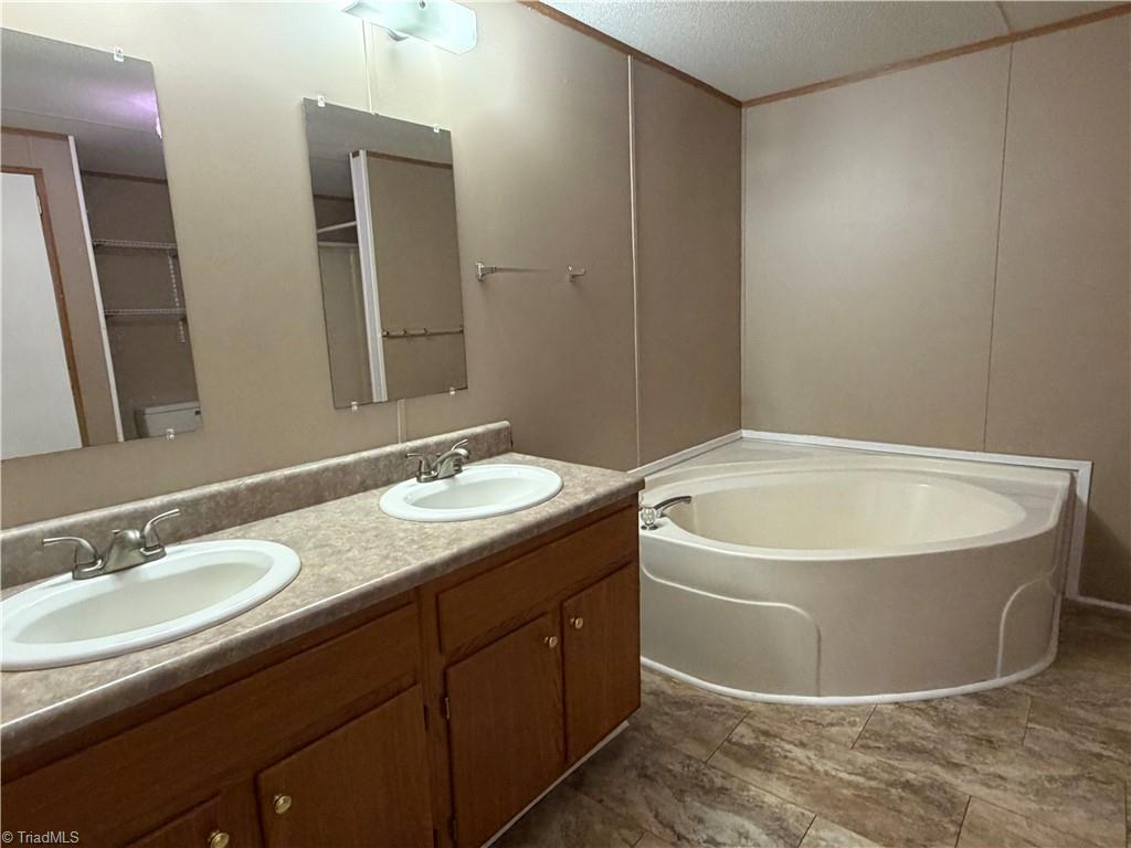 670 Foxwood Road Madison, NC 27025 - Photo 10 of 15 Primary bath has double sinks for lots of bathroom counterspace.