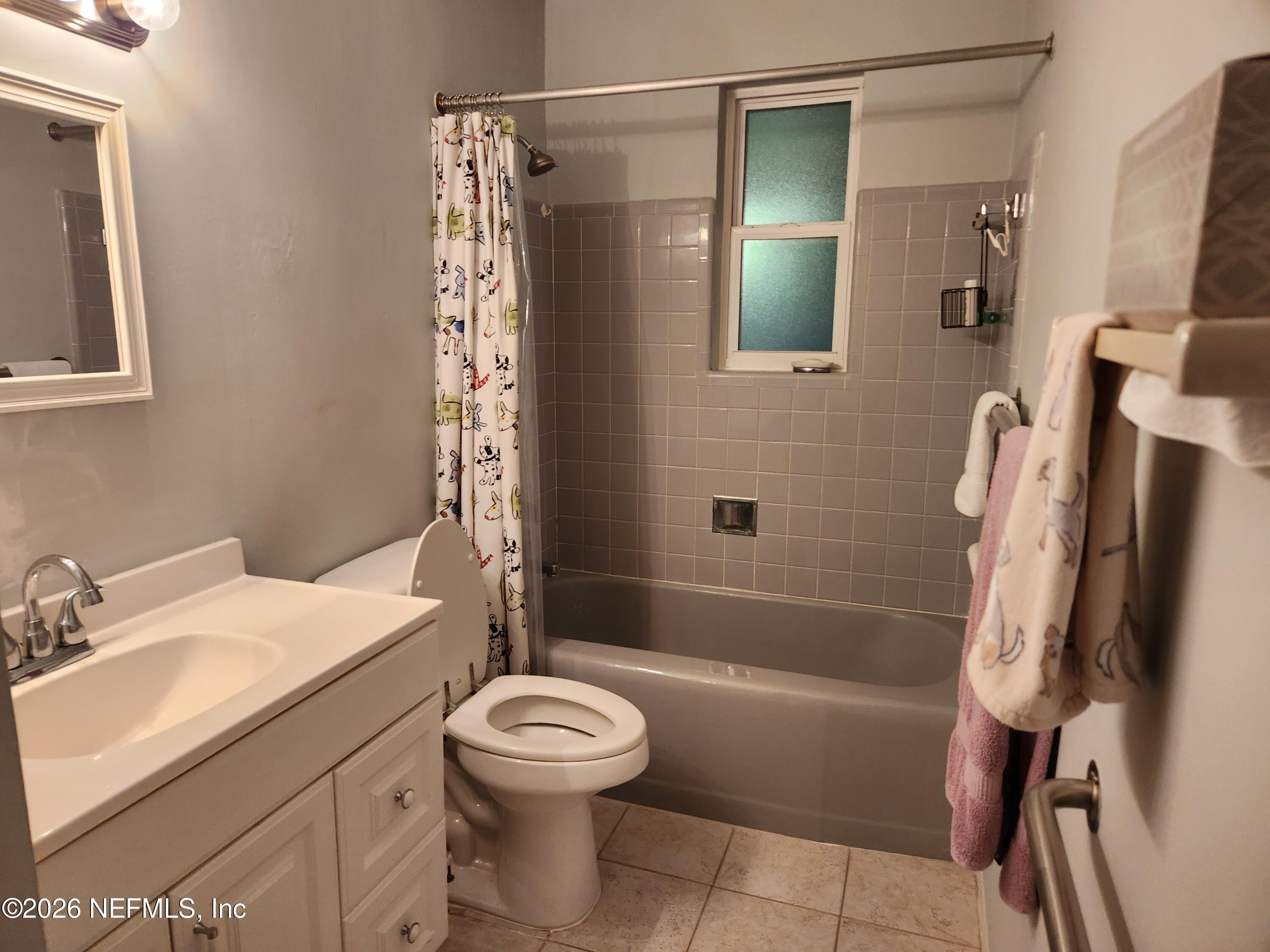 7915 Fresca Street Jacksonville, FL 32217 - Photo 16 of 20 a bathroom with a sink toilet and shower