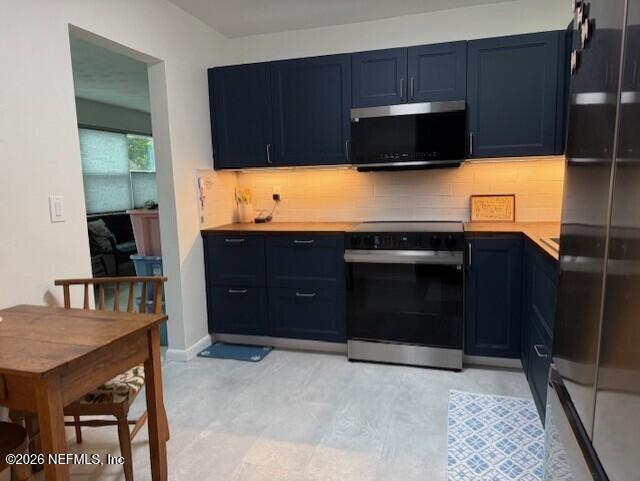 7915 Fresca Street Jacksonville, FL 32217 - Photo 4 of 20 a kitchen with a cabinets and a stove top oven