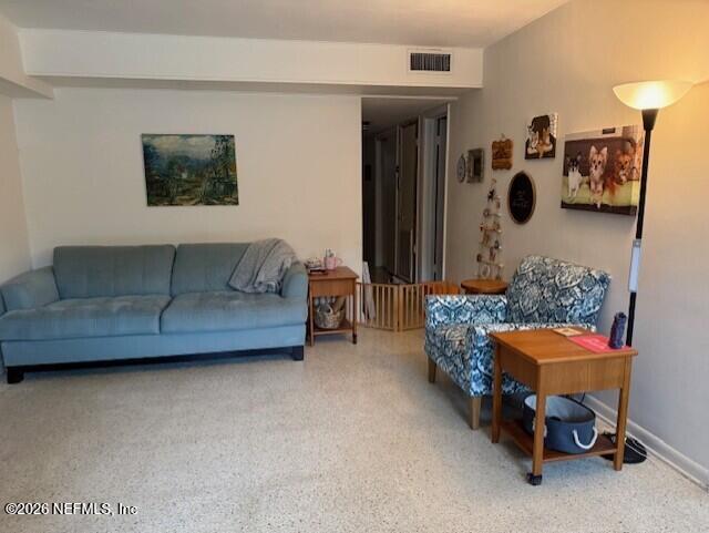 7915 Fresca Street Jacksonville, FL 32217 - Photo 9 of 20 a living room with furniture and a lamp