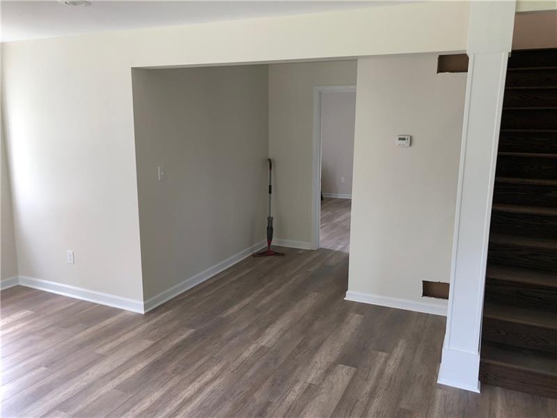 The entry features a new oak staircase with dark walnut stain.