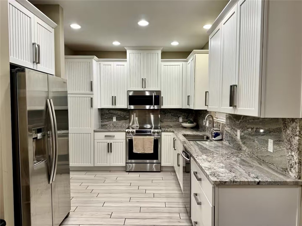 14310 Ridley Way Corpus Christi, TX 78418 - Photo 7 of 19 a kitchen with stainless steel appliances granite countertop a refrigerator a stove and a sink