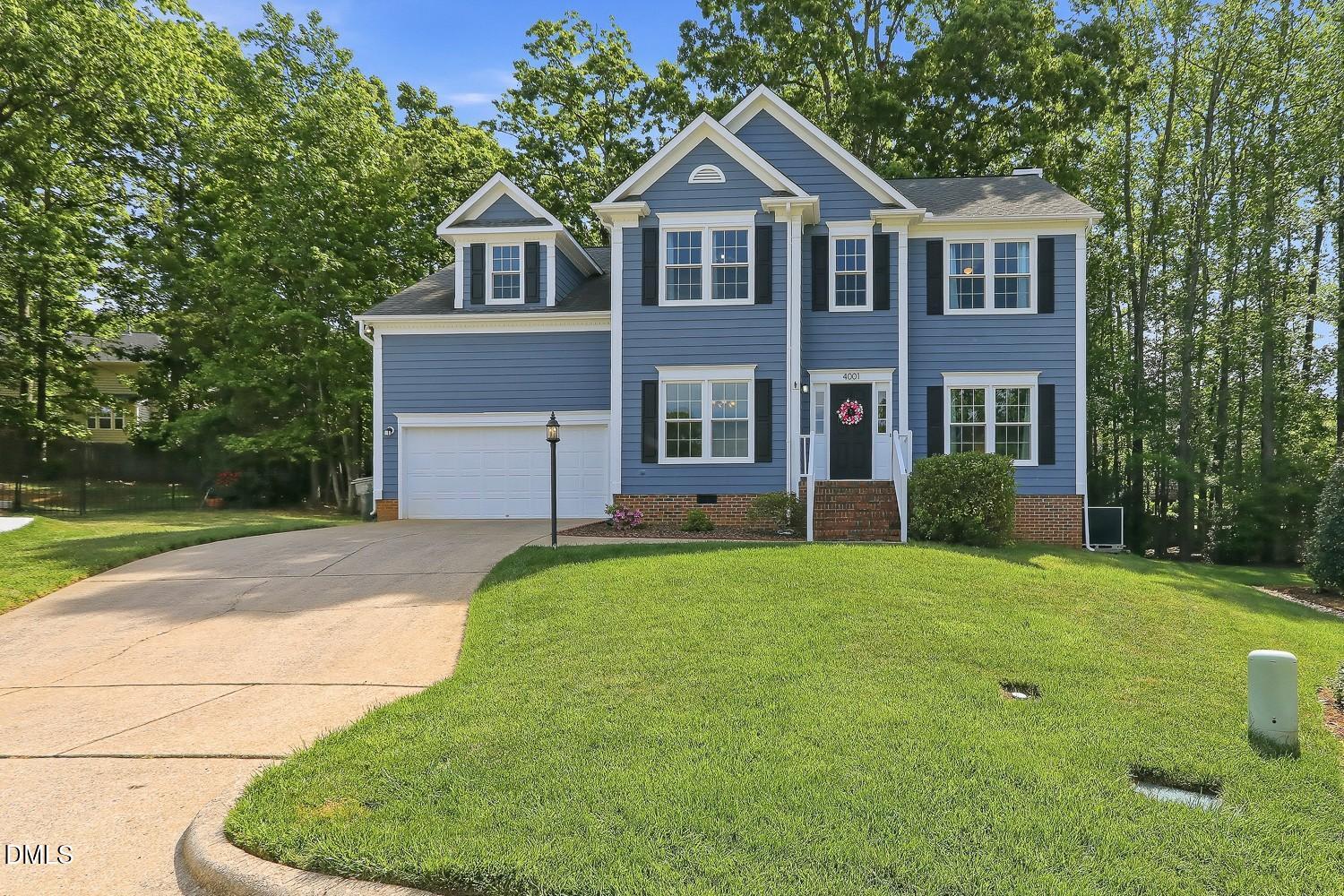 4001 Batiste Road Raleigh, NC 27613 - Photo 3 of 63 a front view of a house with a yard and garage