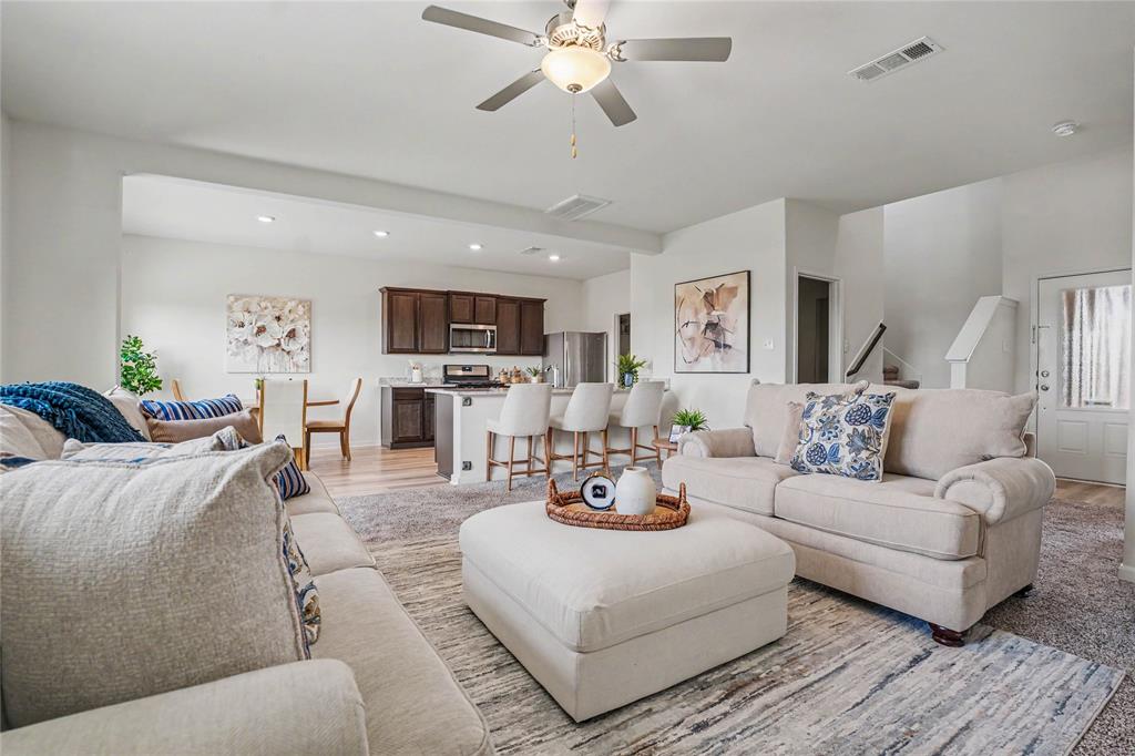 125 Sammy Venus, TX 76084 - Photo 8 of 39 Spacious open-concept living area featuring light-toned walls and a ceiling fan