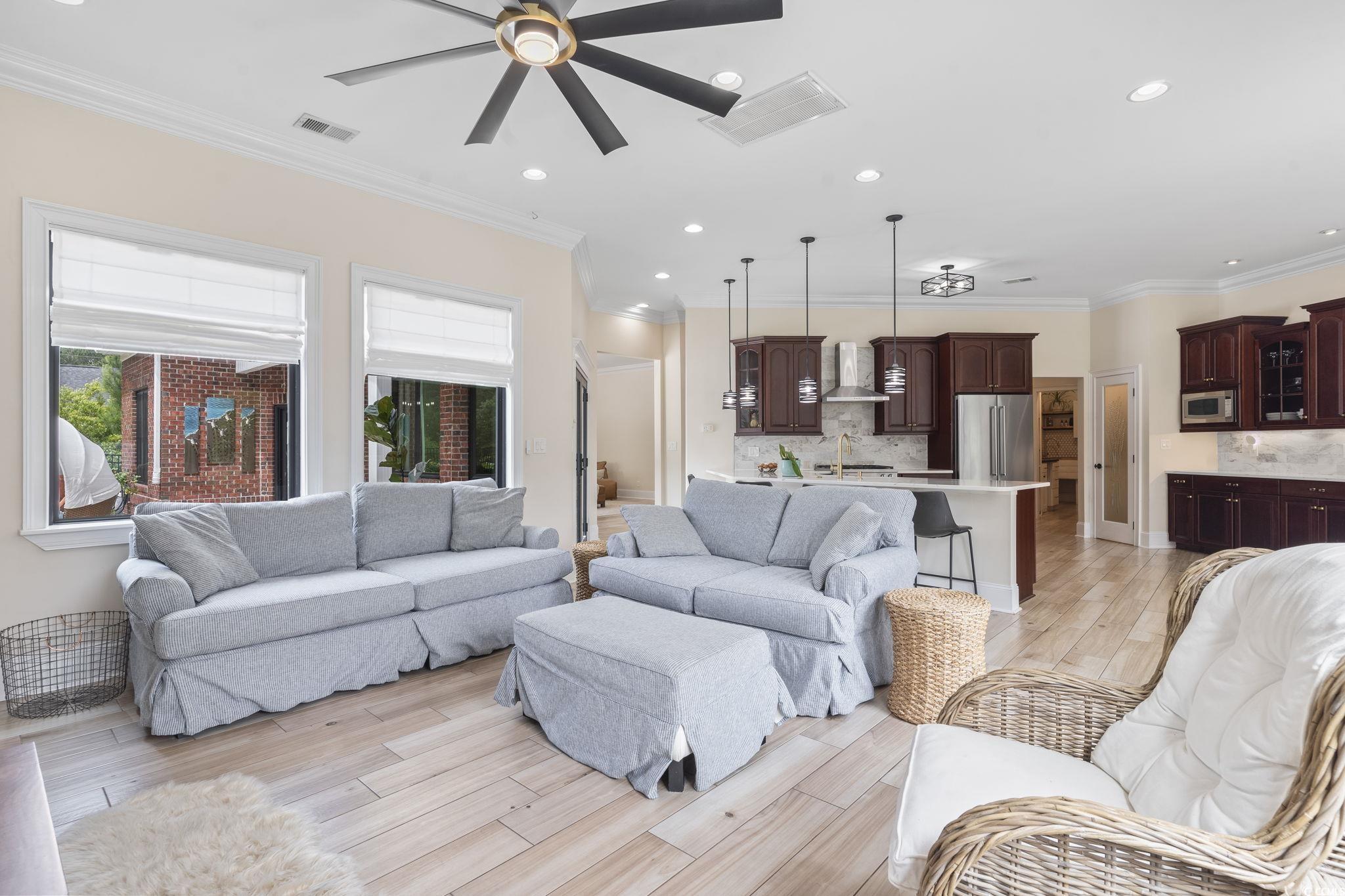 9449 Freewoods Road Myrtle Beach, SC 29588 - Photo 14 of 39 Living room featuring ceiling fan, recessed lighting, light wood-style flooring, and crown molding