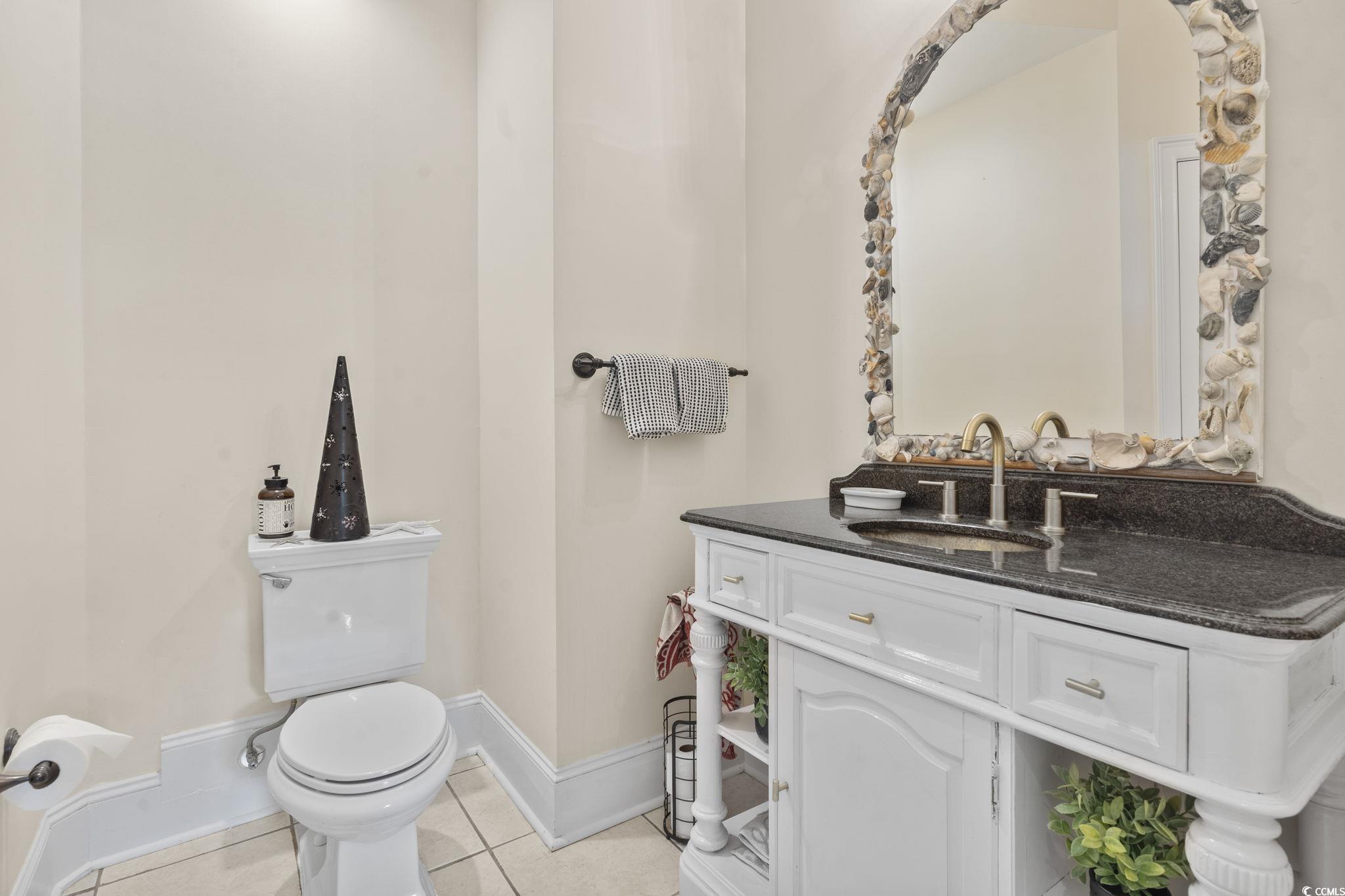 9449 Freewoods Road Myrtle Beach, SC 29588 - Photo 20 of 39 Bathroom featuring tile patterned floors, toilet, baseboards, and vanity