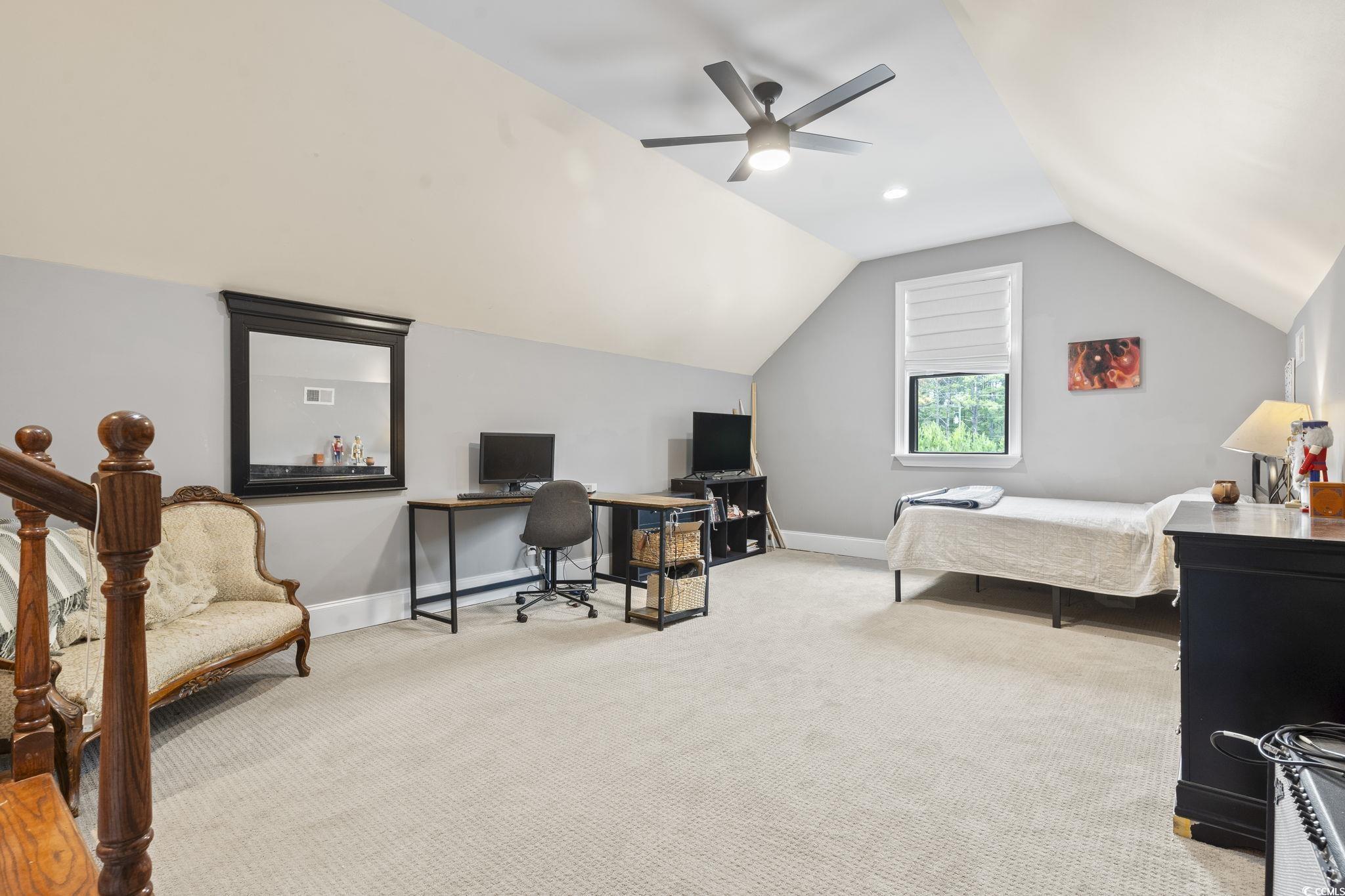 9449 Freewoods Road Myrtle Beach, SC 29588 - Photo 24 of 39 Bedroom featuring an office area, light carpet, vaulted ceiling, a ceiling fan, and baseboards