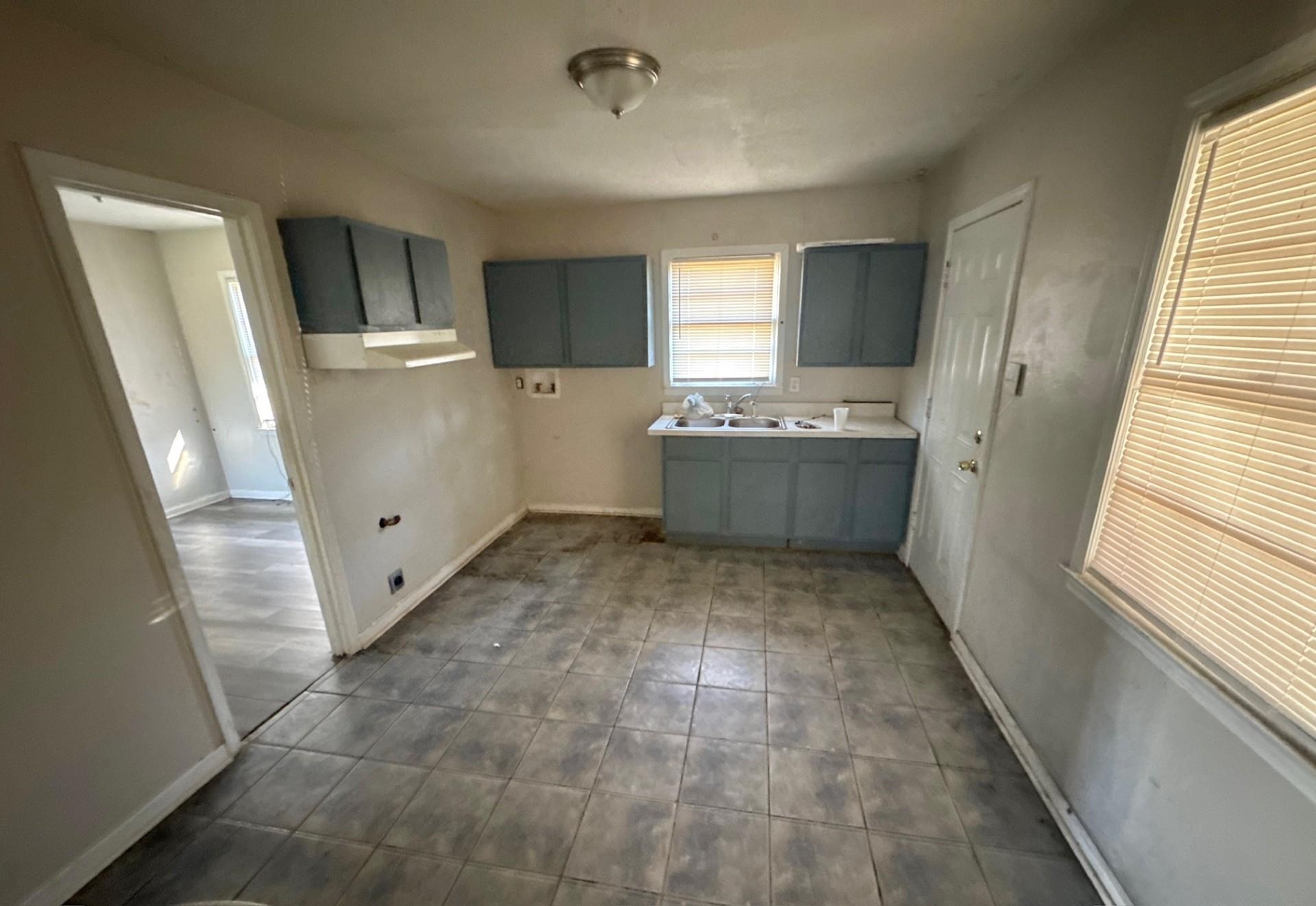 4826 Leonard Road Memphis, TN 38109 - Photo 6 of 8 Kitchen with light countertops and gray cabinets