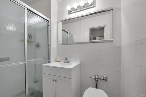 a bathroom with a sink mirror and vanity