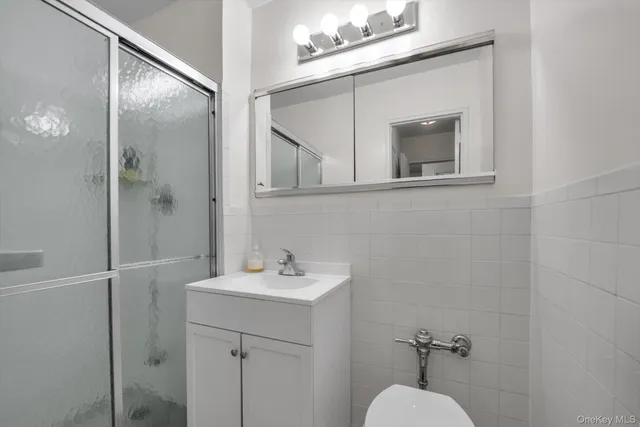 a bathroom with a sink mirror and vanity
