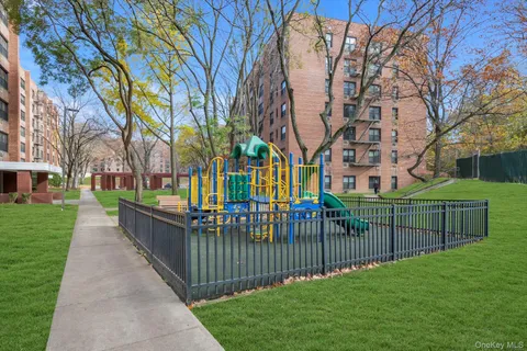 a view of a park with iron fence