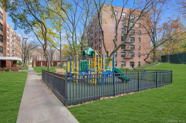 a view of a park with iron fence