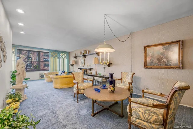 a living room with furniture and a chandelier