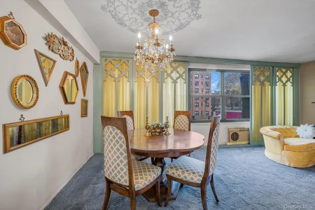 a view of a dining room with furniture and chandelier