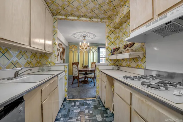 a kitchen with a sink stove and cabinets