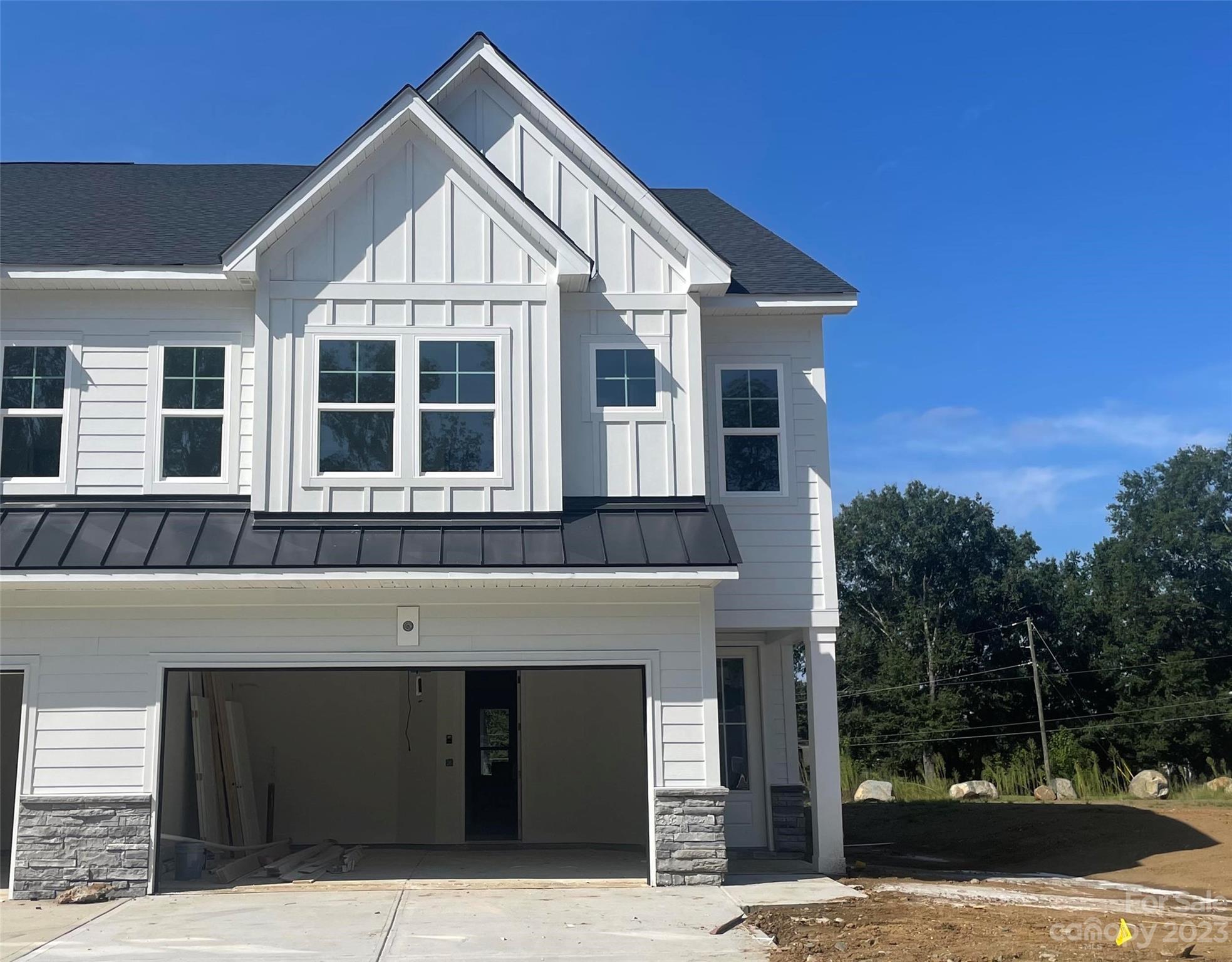6028 Corbin Wds Court Charlotte, NC 28226 - Photo 1 of 3 a front view of a house with a yard