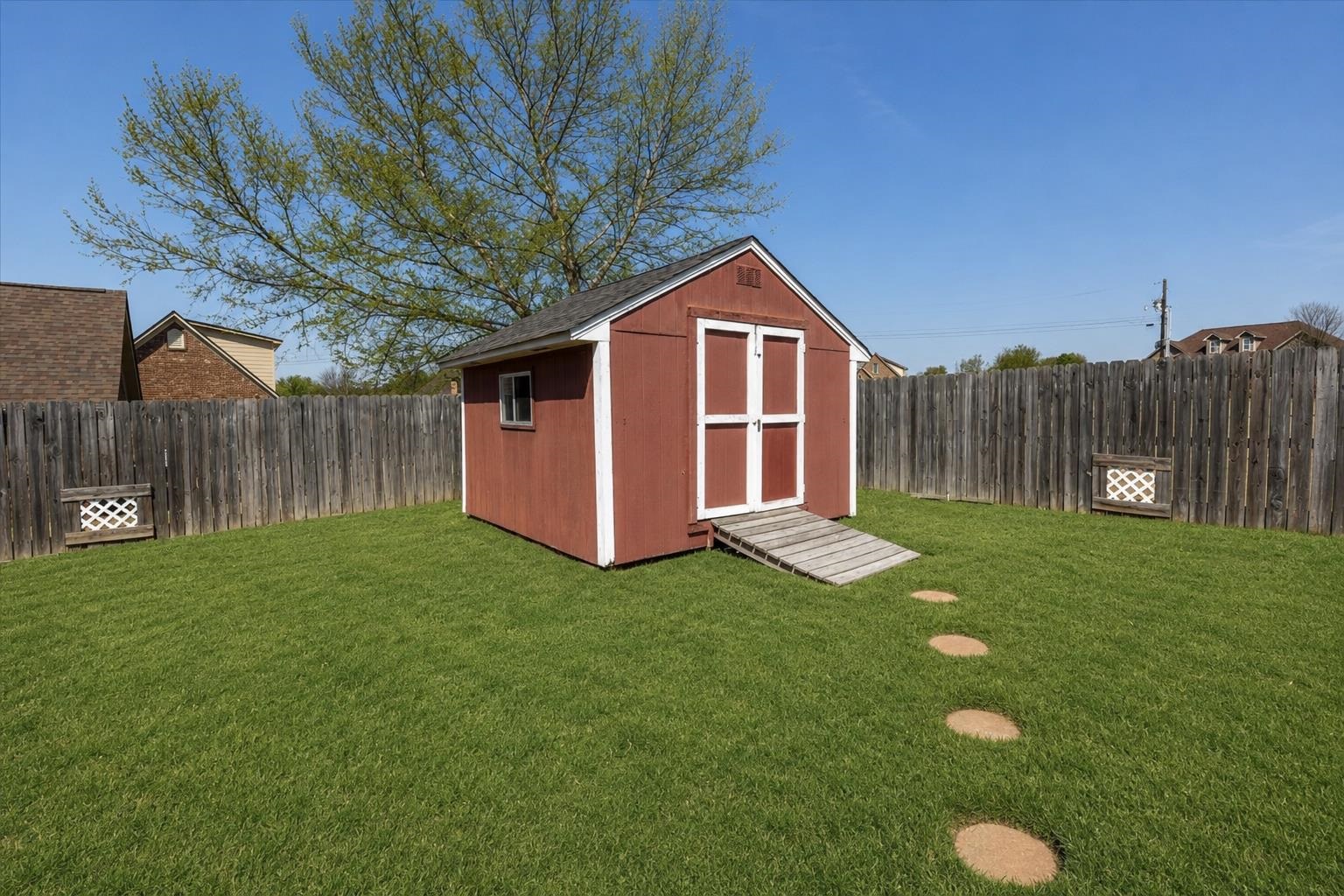168 Clementine Road Atoka, TN 38004 - Photo 25 of 28 a backyard of a house with table and chairs