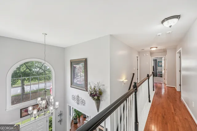 a bed sitting in a spacious bedroom next to a window