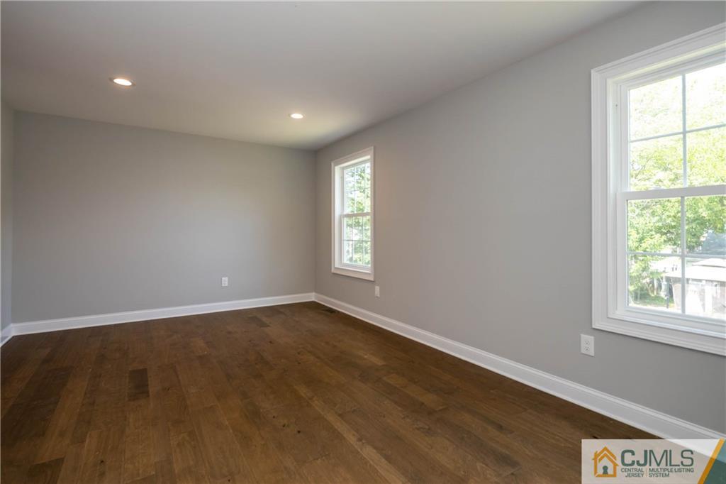 48 Brookville Road Edison, NJ 08817 - Photo 20 of 28 an empty room with wooden floor and windows