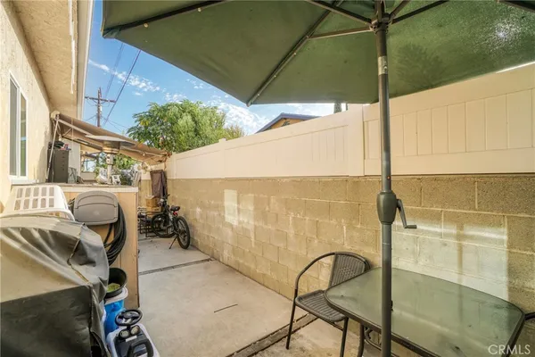 a backyard of a house with table and chairs