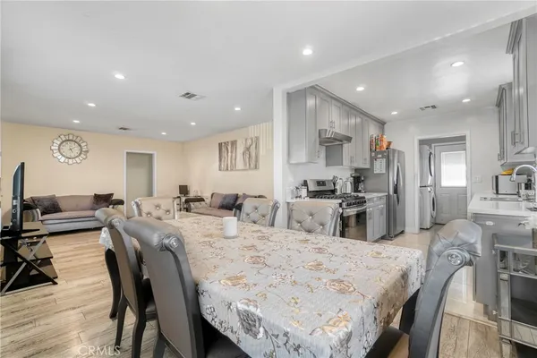 a large kitchen with granite countertop lots of counter space dining table and chairs