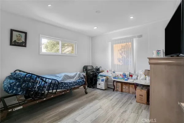 a bed room with furniture and a flat screen tv