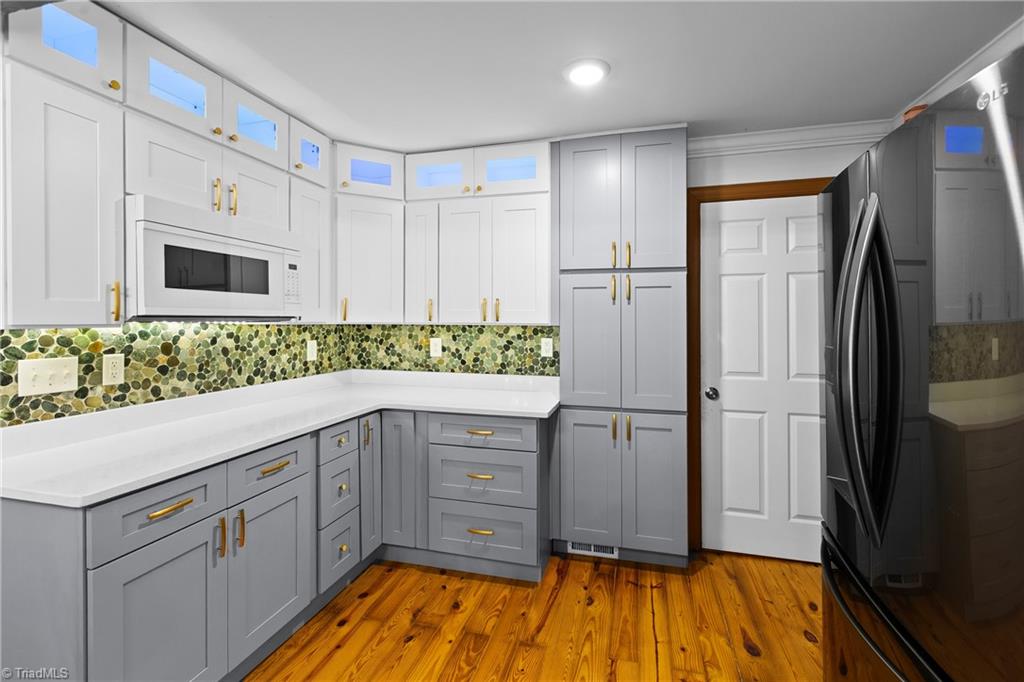 4323 Rader Drive Climax, NC 27233 - Photo 9 of 34 Kitchen cabinets with undermount lighting and lighted upper cabinets