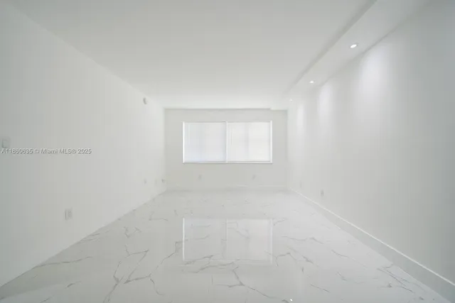 an empty room with a empty space and window