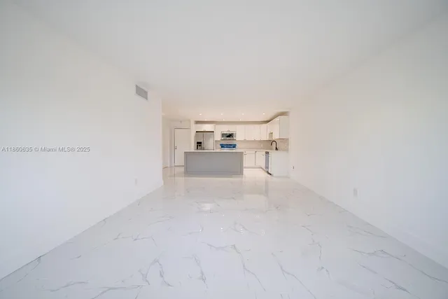 a view of a room with a kitchen