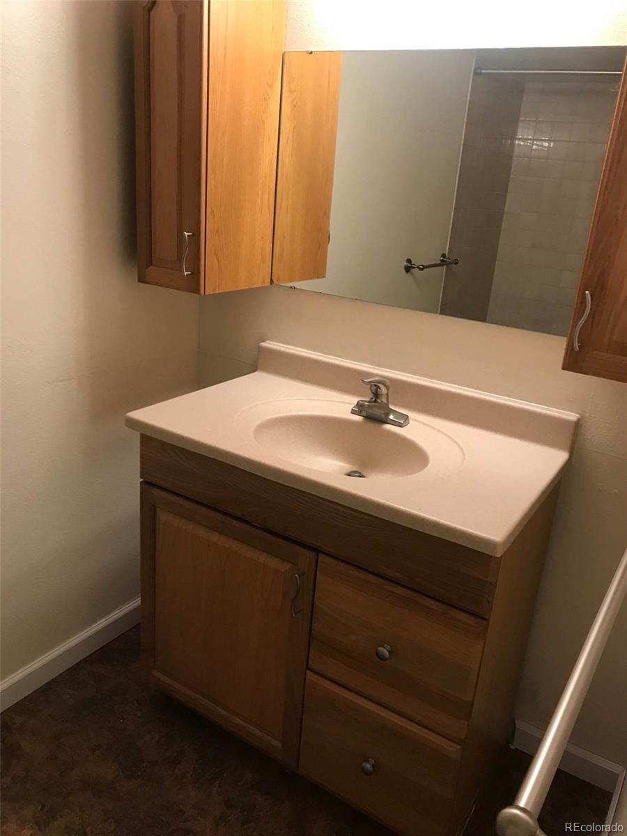 4661 South Decatur Street, Unit 206 Englewood, CO 80110 - Photo 13 of 17 a bathroom with a sink and a mirror