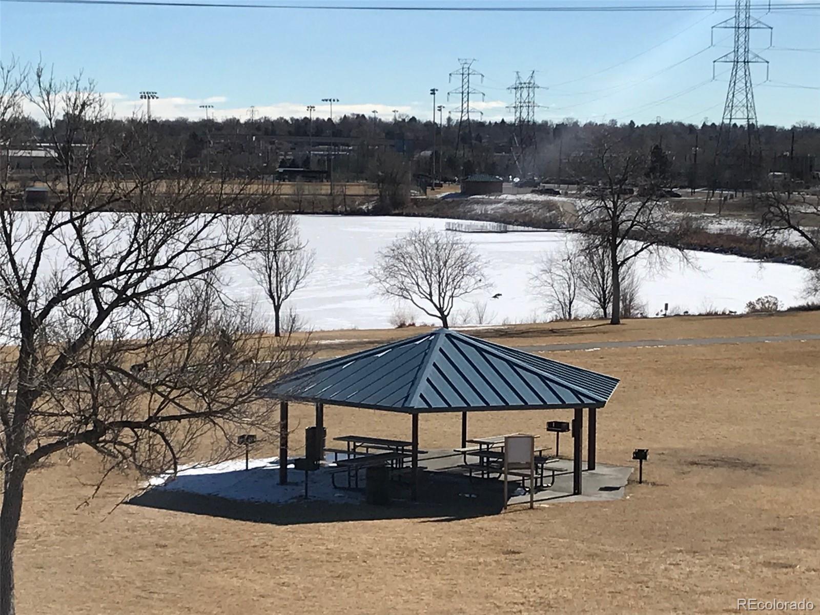 4661 South Decatur Street, Unit 206 Englewood, CO 80110 - Photo 17 of 17 a view of a lake with a table and chairs