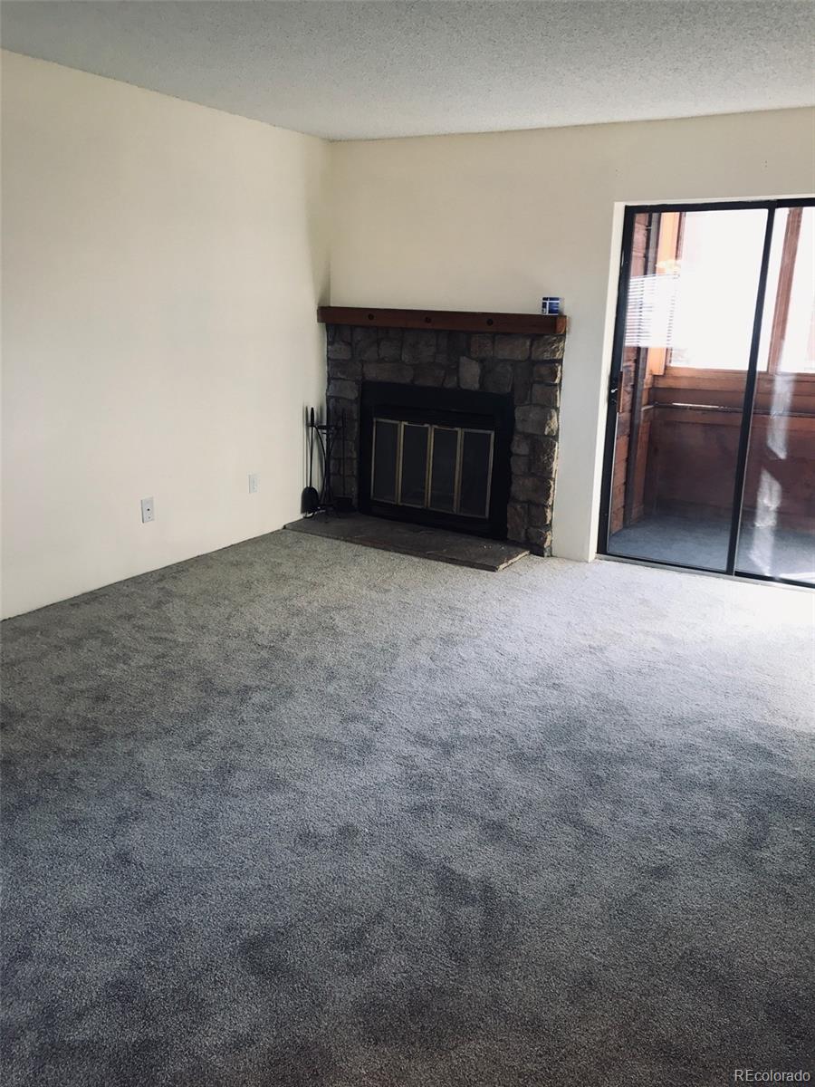 4661 South Decatur Street, Unit 206 Englewood, CO 80110 - Photo 3 of 17 a view of empty room with a fireplace