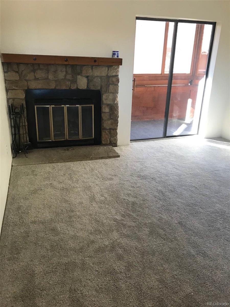4661 South Decatur Street, Unit 206 Englewood, CO 80110 - Photo 4 of 17 a view of empty room with a fireplace