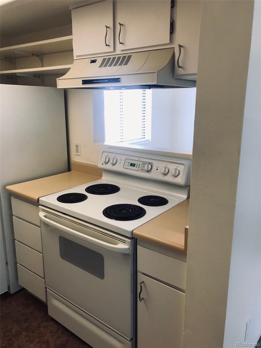 4661 South Decatur Street, Unit 206 Englewood, CO 80110 - Photo 6 of 17 a white stove top oven sitting inside of a kitchen