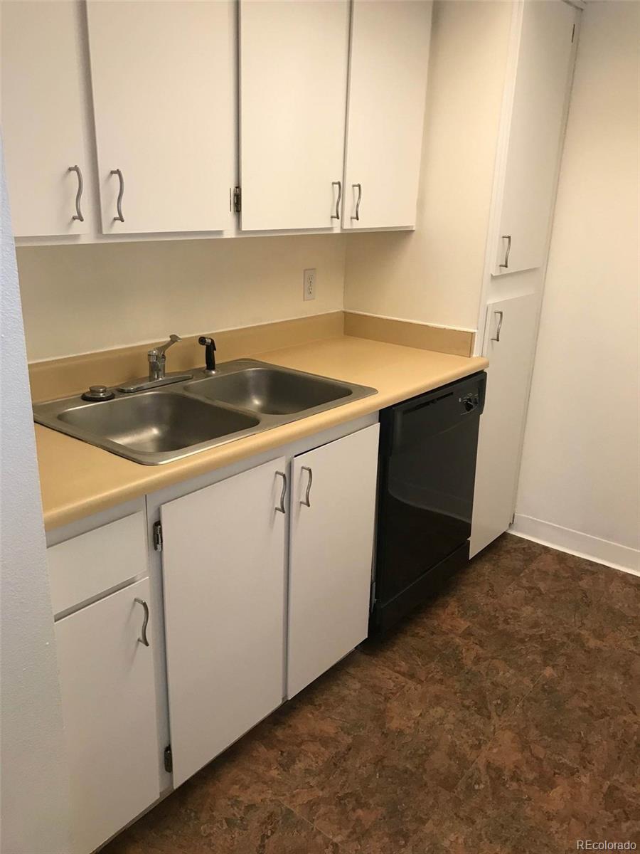 4661 South Decatur Street, Unit 206 Englewood, CO 80110 - Photo 8 of 17 a kitchen with a sink and cabinets