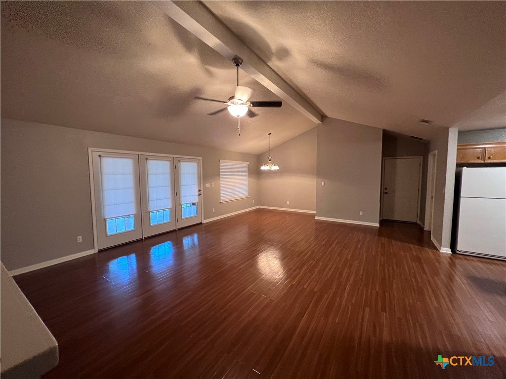 1241 Rapids Road New Braunfels, TX 78130 - Photo 11 of 27 a view of an empty room with wooden floor and a window