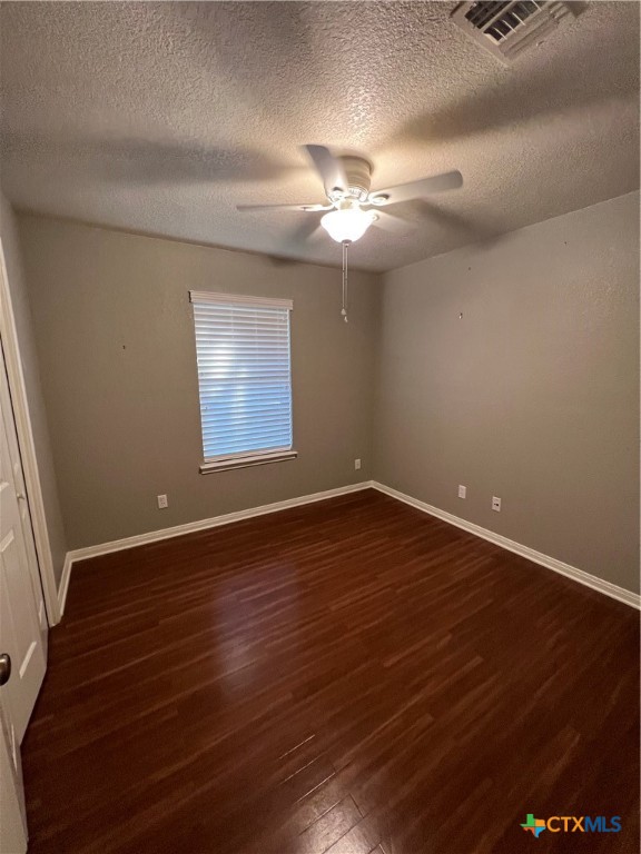 1241 Rapids Road New Braunfels, TX 78130 - Photo 14 of 27 a view of an empty room with wooden floor and a window