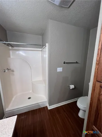 a bathroom with a glass shower door