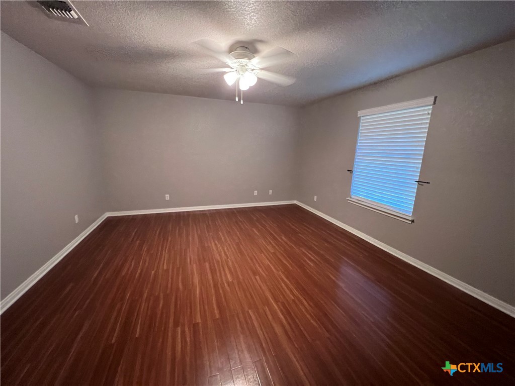 1241 Rapids Road New Braunfels, TX 78130 - Photo 21 of 27 wooden floor in an empty room with a window