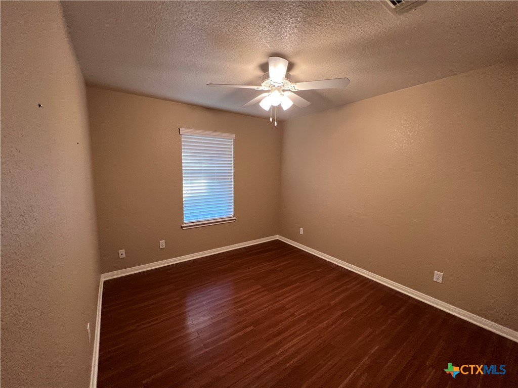 1241 Rapids Road New Braunfels, TX 78130 - Photo 23 of 27 a view of an empty room with window and wooden floor